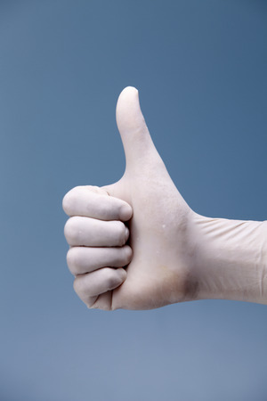 Hand shows the gesture on a coloured background.の写真素材