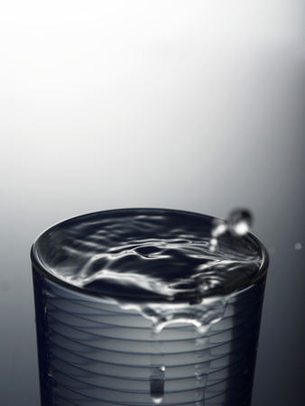 Water splashing out of a cup.の写真素材