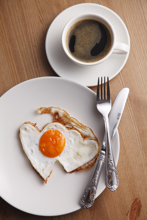 romance breakfast with heart shape fried eggの写真素材