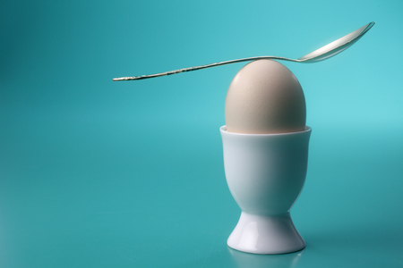 spoon welll balance on top of eggの写真素材