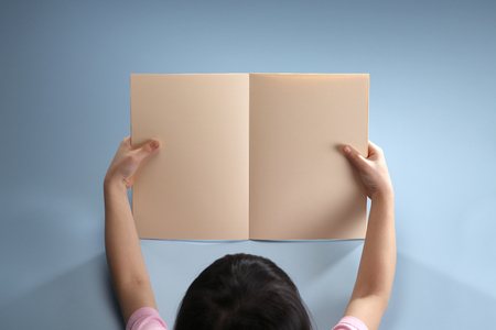 Stock image of a girl holding a blank book.の写真素材