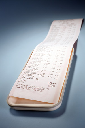 Reciept on a white tray.の写真素材