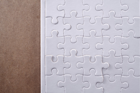 Completed jigsaw puzzle isolated on wooden table.の写真素材