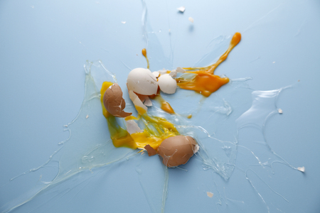 Egg yolk and egg white splattered.の写真素材