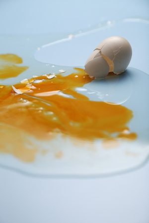 Egg yolk and egg white splatteredの写真素材
