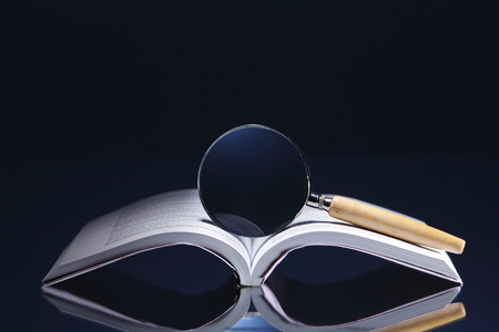 Magnifier on top of an opened book.の写真素材