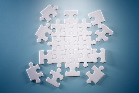 Puzzle pieces isolated on the blue background.
