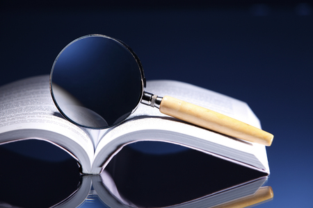 Magnifier on top of an opened book.の写真素材