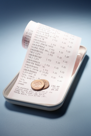 Reciept with change isolated on background.の写真素材