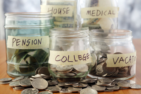 Bottles of cash with coins isolated on the background.の写真素材