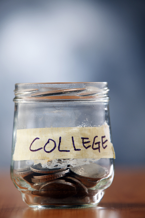 Jar with coins labeled college.の写真素材