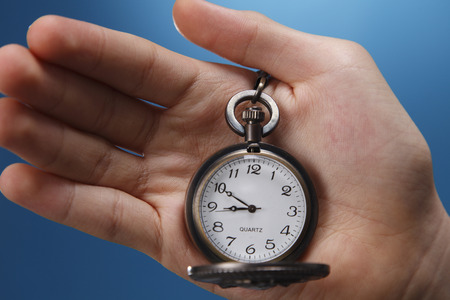 Human hand holding a pocket watch.の写真素材