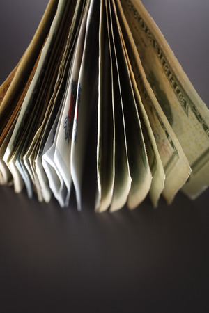 Stack of banknotes isolated on the black background.の写真素材