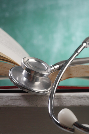 stethoscope resting on the bookの写真素材