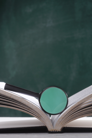 magnifier resting on the open page bookの写真素材