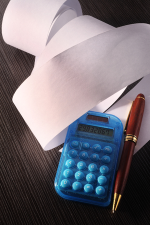 stock image of the rolled of paper and calculatorの写真素材