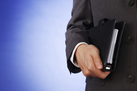 Hand holding date book and daily plannerの写真素材