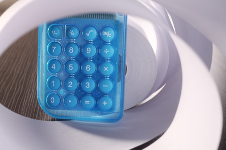 stock image of the rolled of paper and calculatorの写真素材