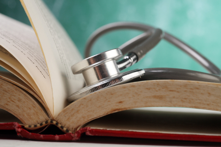 stethoscope resting on the bookの写真素材