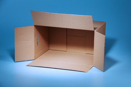 Empty Cardboard Box on the blue backgroundの写真素材