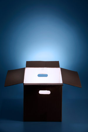 Glowing rays of light coming out of an open box