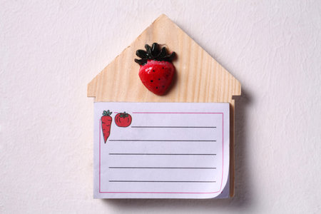 blank note on house shaped board