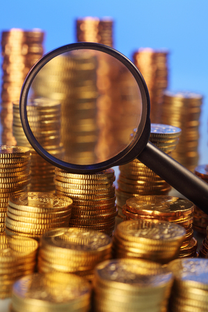 coins and magnifying glassの写真素材
