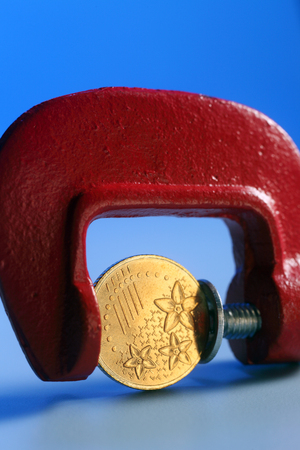 Coin Trapped in Clampの写真素材