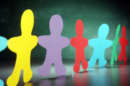 multi color paper cut-out men in a rowの写真素材