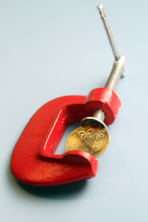 Coin Trapped in Clampの写真素材