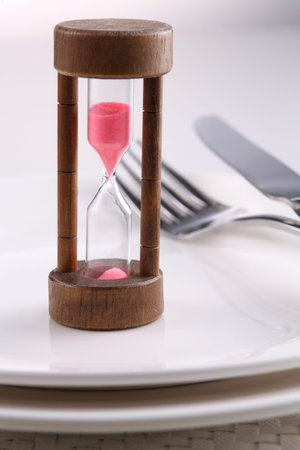 close up of the hourglass on the dinner plate