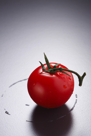 Tomato with droplets of waterの写真素材