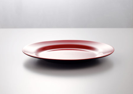 Empty red plate on the white background