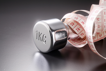 close up of the measuring tape on the dumbbellの写真素材