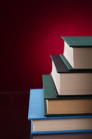 stack of the books on the red backgroundの写真素材