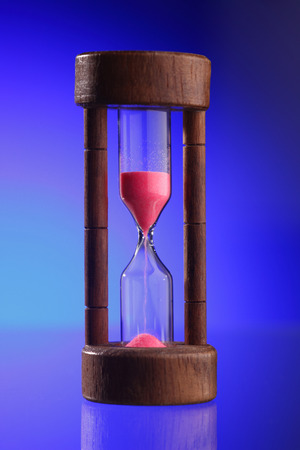 Close up of the hourglass on the blue backgroundの写真素材