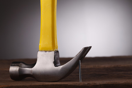 Hammer hooked over bent nail, close-upの写真素材