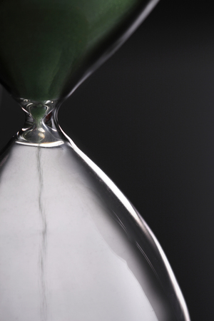 Sand funneling through hour glassの写真素材