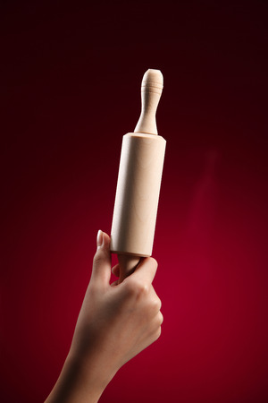 child holding a wooden rolling pinの写真素材