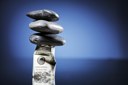 money stack under the stoneの写真素材