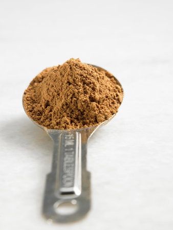 Studio shot spoon of cinnamon powder