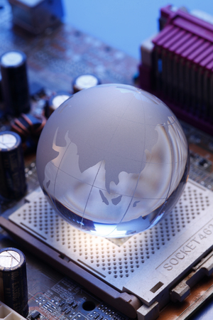 glass globe on the computer mother boardの写真素材