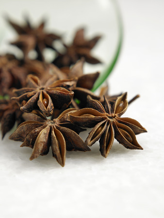 anise star pouring out from green saucerの写真素材