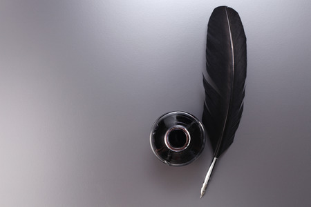 quill pen next to the ink wellの写真素材