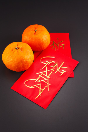 chinese new year red envelope and mandarin orangesの写真素材