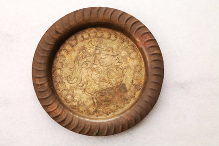 round copper plate on the  mable tableの写真素材