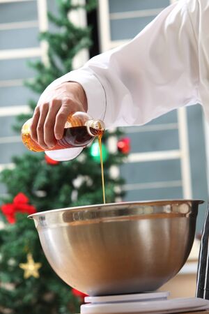 pouring golden syrup in the mixerの写真素材