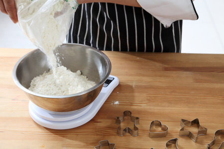 pouring flour to the mixer