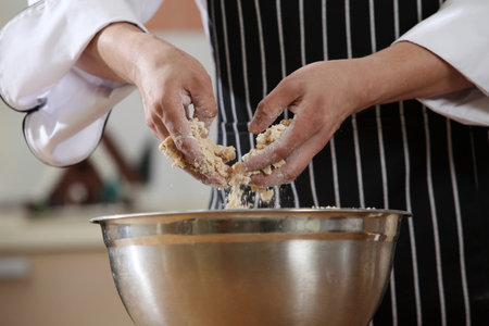 Kneading the dough in the mixing bowlの写真素材