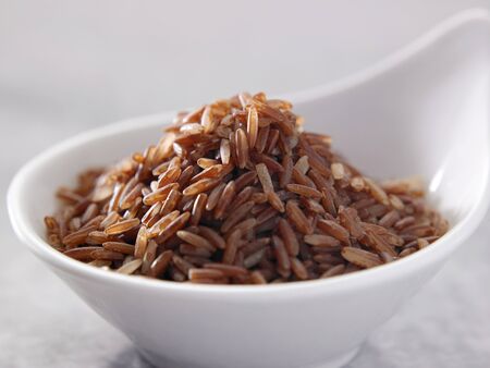 bowl of uncook brown riceの写真素材